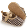 A pair of tan woven baby walking shoes with anti-slip soles and a matching sole shown from the top.