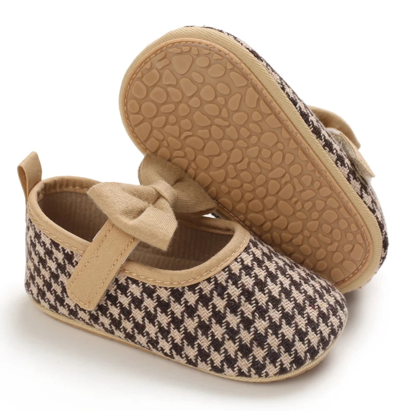 A pair of tan woven baby walking shoes with anti-slip soles and a matching sole shown from the top.