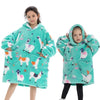 A young girl models a teal fuzzy hoodie sweater with white and pink animal patterns.