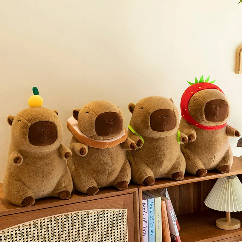 A row of three brown capybara plush toys sitting on a wooden shelf.