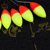 A row of bright red and yellow oval fishing floats with bobber beads are displayed against a dark background.