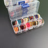 A clear plastic storage box filled with a variety pack of colorful celluloid guitar picks.
