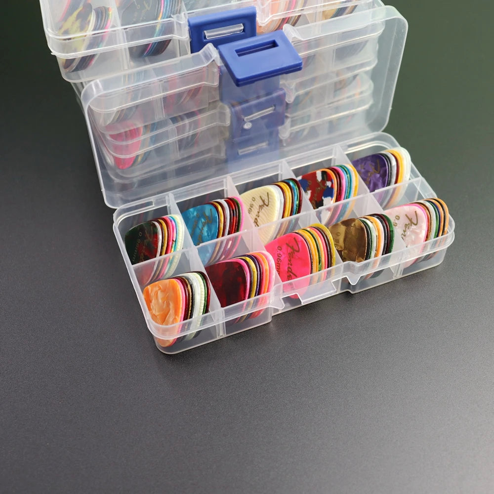 A clear plastic storage box filled with a variety pack of colorful celluloid guitar picks.