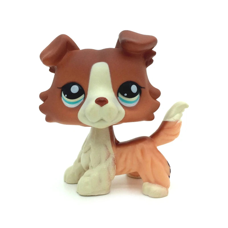 A small, standing dog figure resembling a brown and white terrier mix with large eyes.
