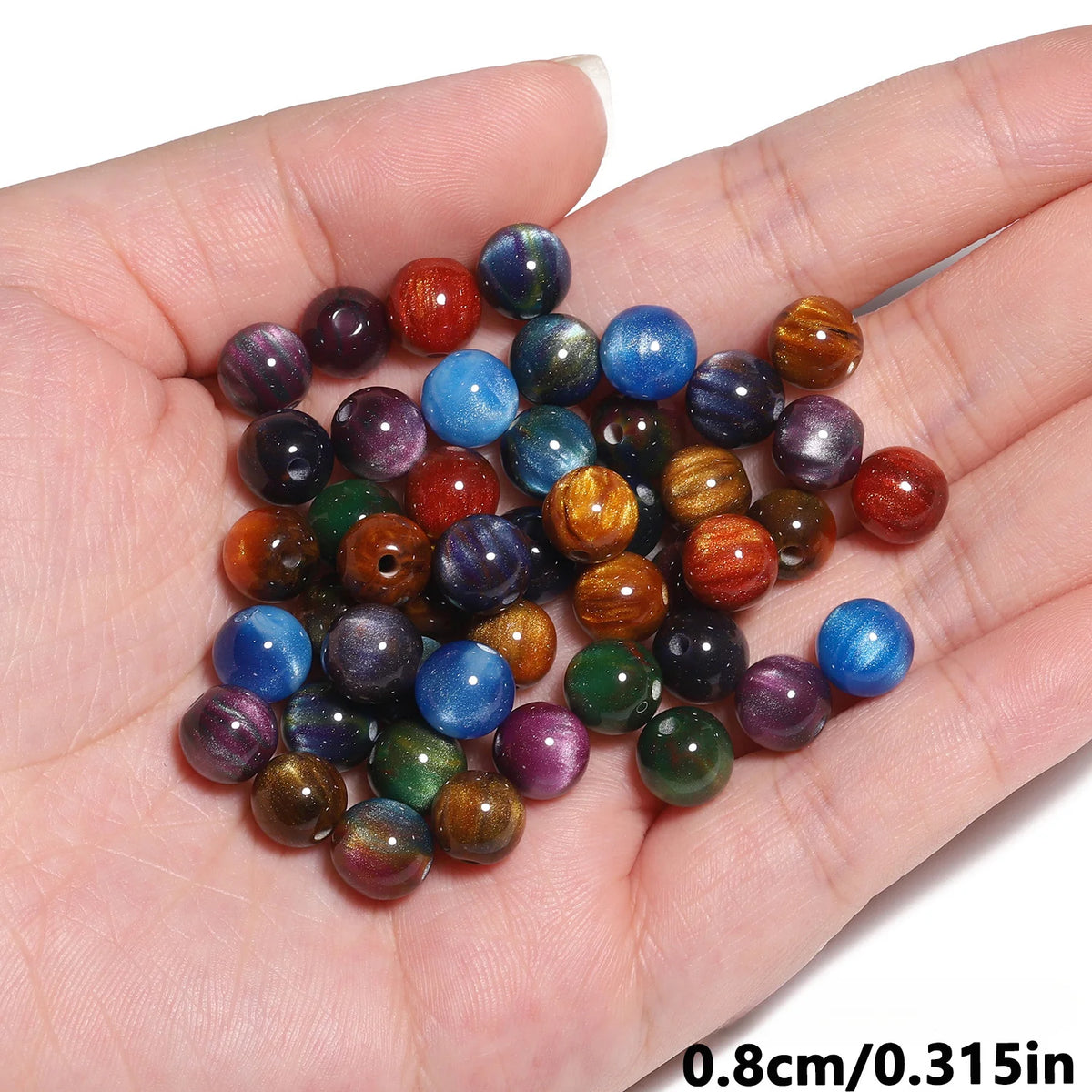 A handful of vibrant tiger eye resin beads in various shades of brown, blue, and purple.