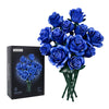 A bouquet of realistic blue roses in a green vase displayed next to its packaging box.