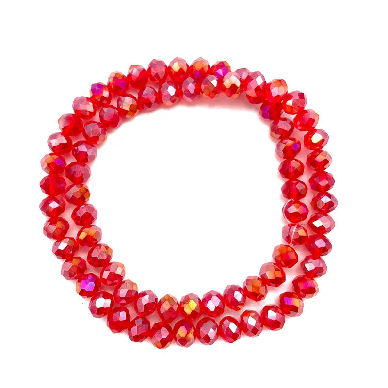 A circular strand of faceted red crystal beads used for jewelry making