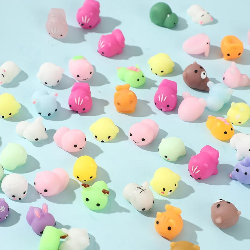 A collection of 50 small, squishy, kawaii animal-shaped stress relief toys in various pastel colors and textures.