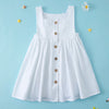 A white summer cotton linen jumper dress for a toddler girl displayed against a light blue background.