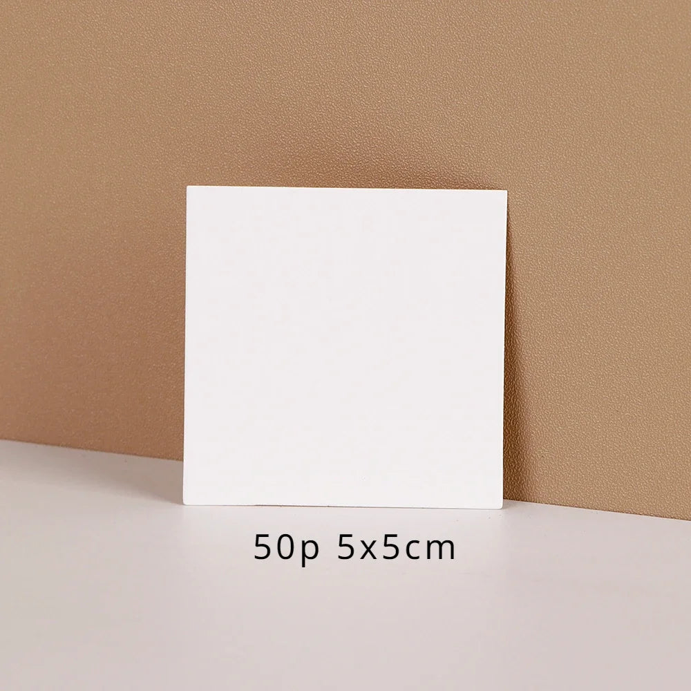 A white square jewelry display card is shown against a beige background with the text 50p 5x5cm below it.