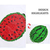 A close-up of a red watermelon design made with sequins on a white shirt, next to a green watermelon design.