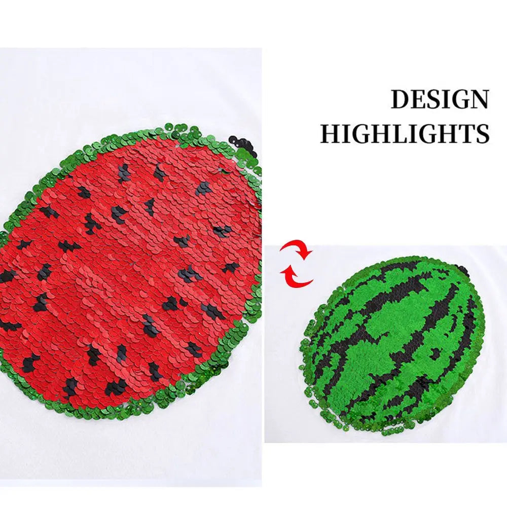 A close-up of a red watermelon design made with sequins on a white shirt, next to a green watermelon design.
