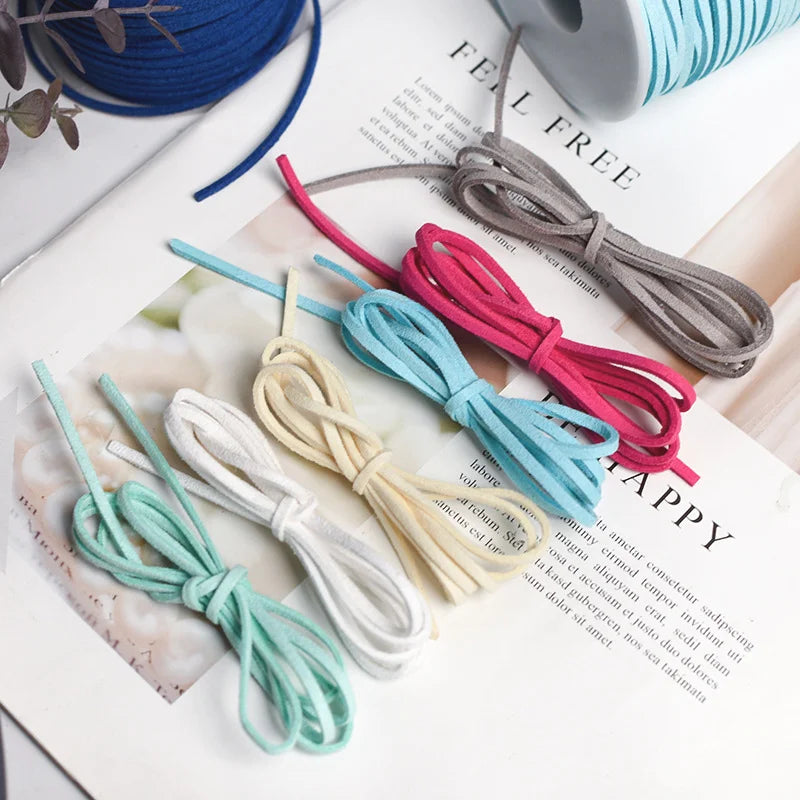 A collection of various colored braided ribbon rolls in blue, pink, white, and gray laid out on a white surface.