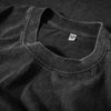 A close-up shot of a dark gray, retro washed heavyweight cotton t-shirt with a crew neck collar.