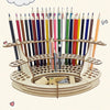 A wooden organizer holds numerous colored art brushes and pencils in individual slots.