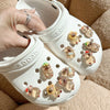 A pair of white Crocs shoes decorated with glow-in-the-dark capybara charms.