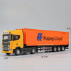 Diecast orange and yellow Scania truck model with a container, shown from the side.