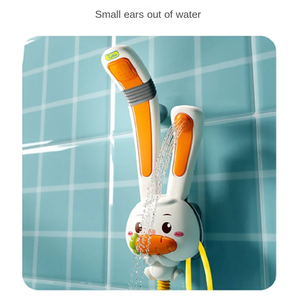 A white rabbit-shaped electric bath shower toy is spraying water in a tiled bathroom setting.