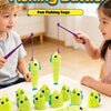 Two children play a fishing battle game with colorful plastic fish toys on a white table.