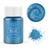 A glass jar of blue pearl powder with a swirling texture and a separate pile of the same blue powder.