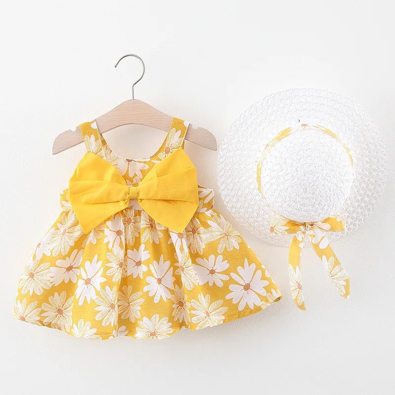 A yellow floral baby girl summer dress and sunhat set with a matching bow detail.