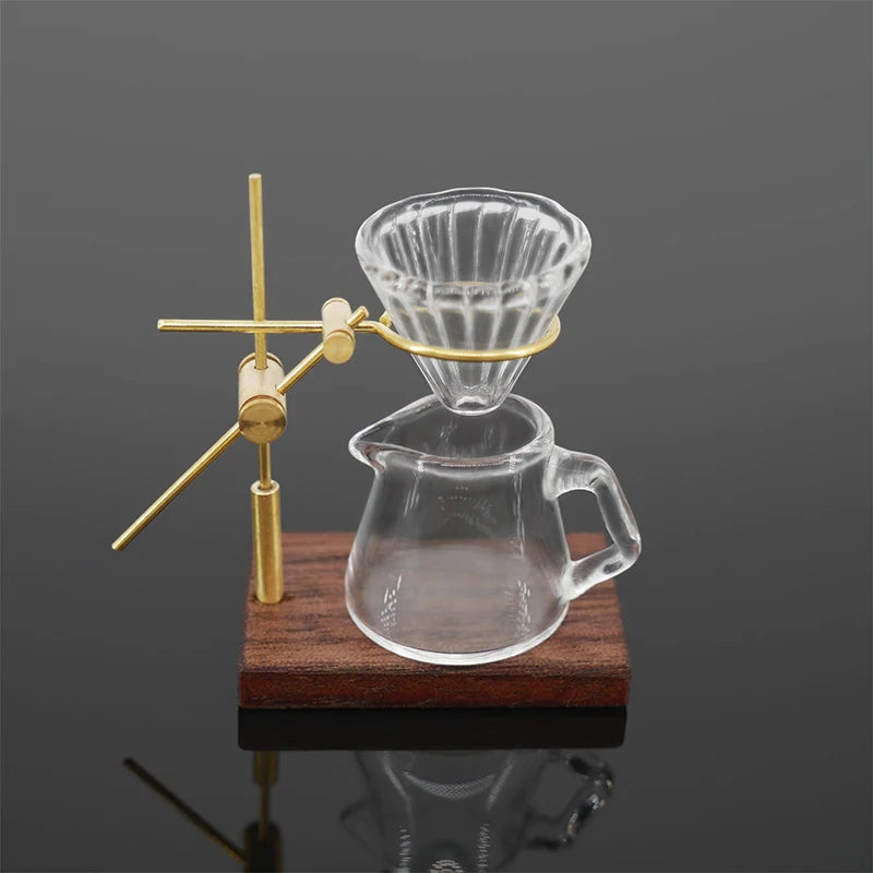 A miniature hand-brewed coffee stand set for dollhouse featuring a glass teapot and a pourer.
