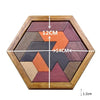 A wooden tangram puzzle set with colored pieces arranged in a hexagonal frame.