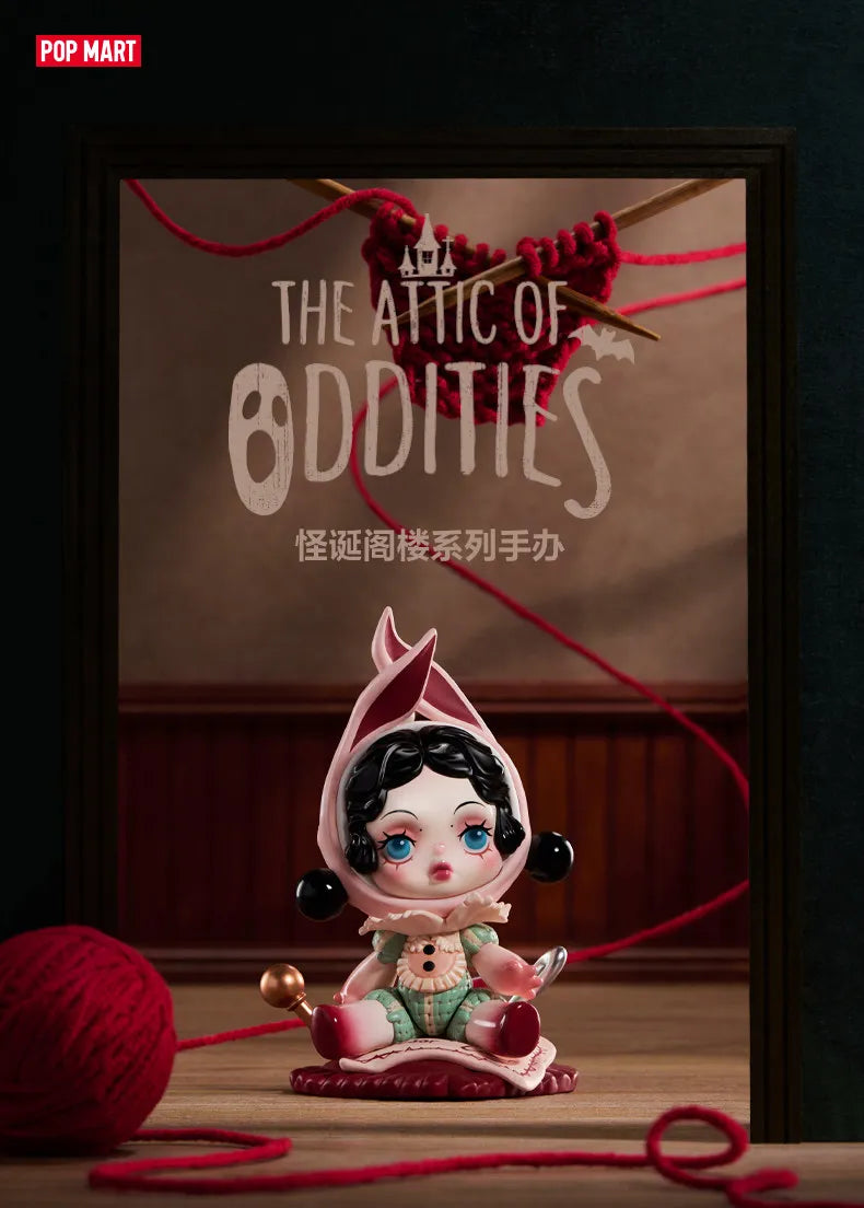 A collectible figure blind box of a girl with pink hair and clothing is displayed in a dark frame.