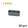 A gray Technic liftarm beam with three holes, sold as a 20-piece set of building blocks.