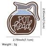 A brown embroidered patch shaped like a bottle with a spout and a gray fabric neck, featuring the text POT head.