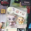 A plastic packaging shows three small purple and yellow animal figures, including a cat and a lion cub.