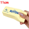 A yellow salted butter stick squishy toy being held by a hand.