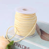 A roll of yellow velvet faux suede braided ribbon for crafting and gift wrapping