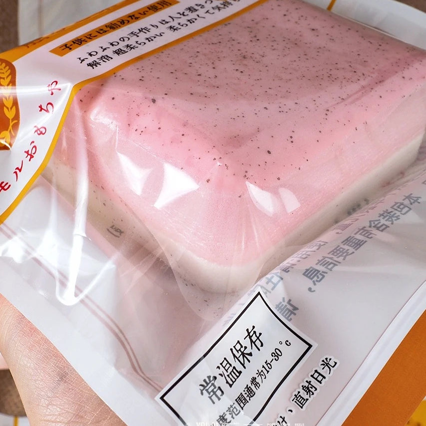 A pink slow-rise toast squishy stress relief toy is shown in its packaging.