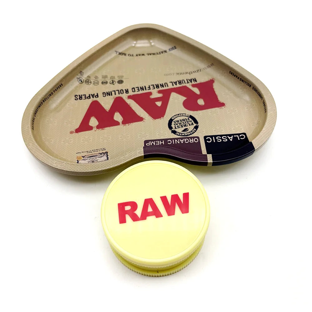 A light tan, love-shaped metal rolling tray with a yellow lid and red lettering on the surface.
