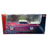 Die-cast model of a vintage 1959 Chevrolet Impala car in red and white on a collector's edition display box.