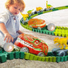 A child is interacting with a green dinosaur train track set featuring orange and yellow dinosaurs.