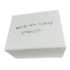 A white box with handwritten text on the lid that reads We're not really strangers.