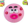 A pink moldable dog face squishy stress relief toy with black and white features.