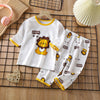 White long sleeve cotton pajama set for children featuring a lion print and yellow trim