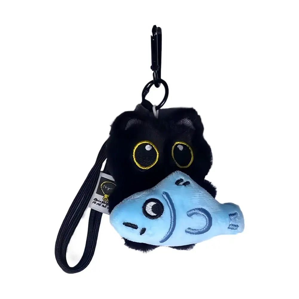 A cute plush black cat keychain with a light blue face and eyes.