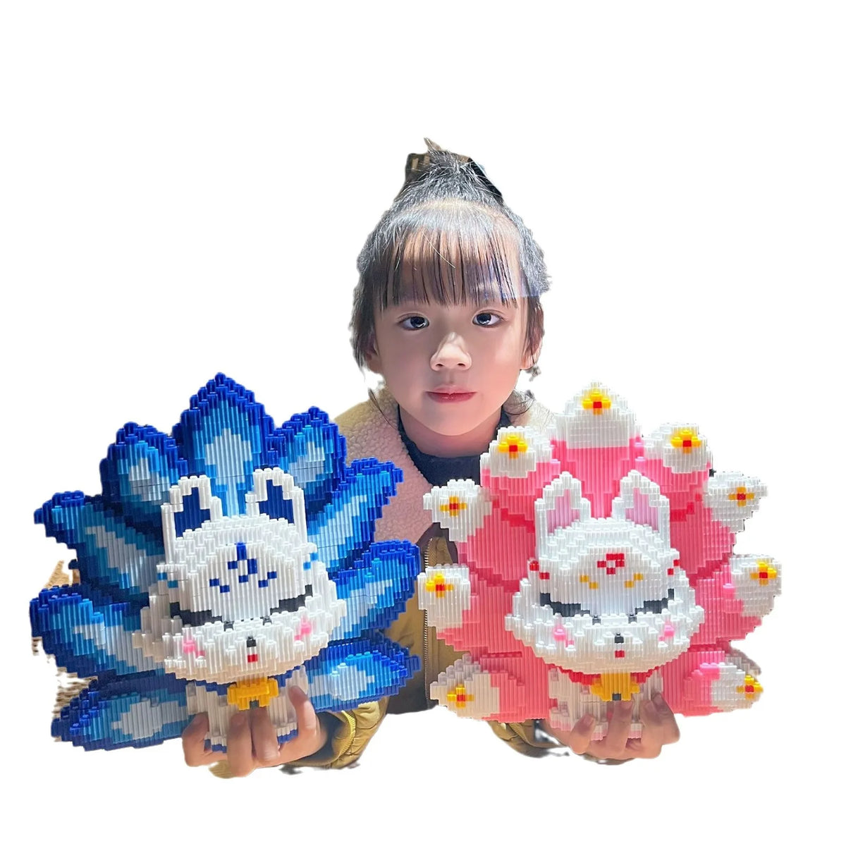 A person holds a building block set depicting a nine-tailed fox character in blue and white.