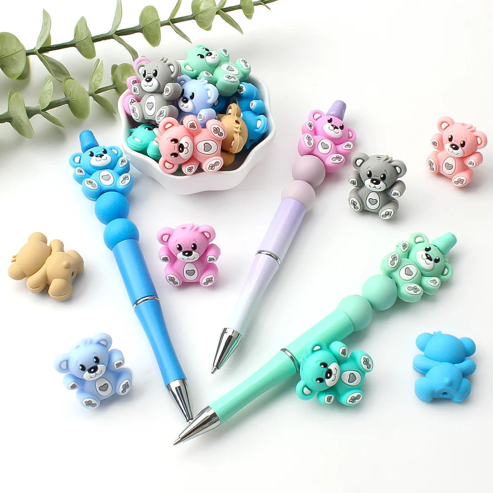 A collection of colorful 3D silicone bear focal beads in various shades and sizes for DIY jewelry making.