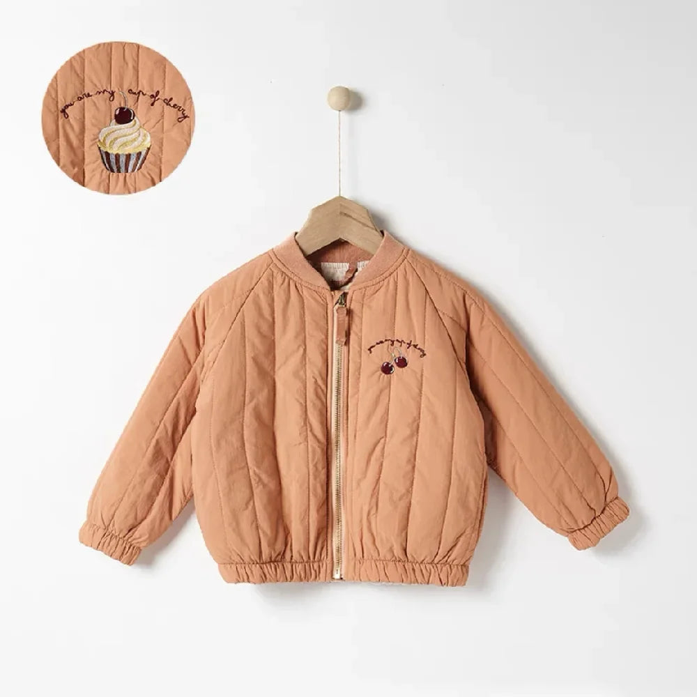 A light brown padded jacket for kids featuring a letter print on the chest, displayed on a hanger.