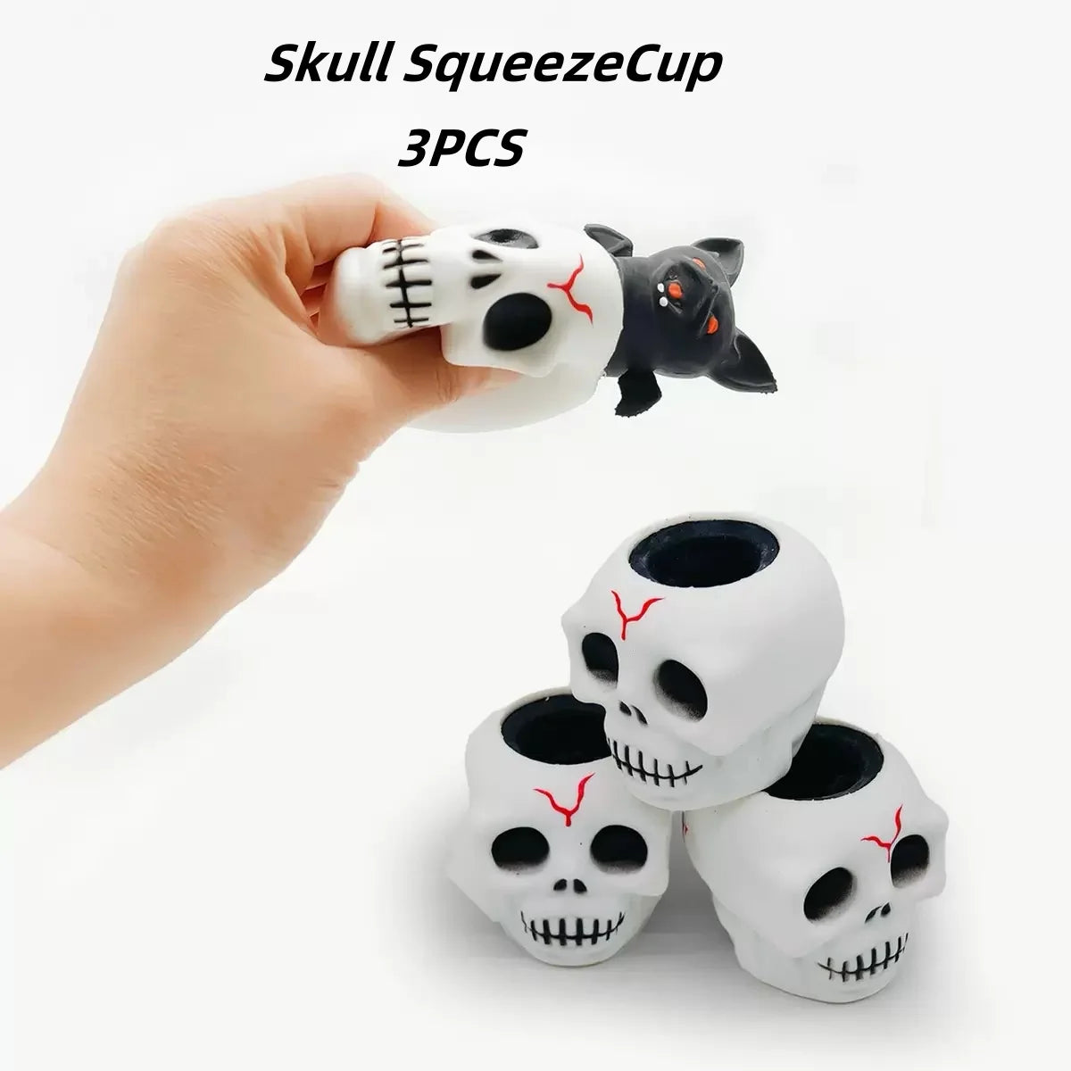 Three skull squeeze cups featuring black and white designs are held in a hand.
