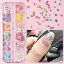 A collection of 3D floral nail art decals in various colors is shown alongside an application on a fingernail.