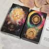 A deck of Lune de L'Univers Tarot cards featuring intricate gold and purple designs on a dark background.
