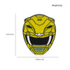 A yellow and black enamel pin featuring a dinosaur ranger battle suit and helmet design.