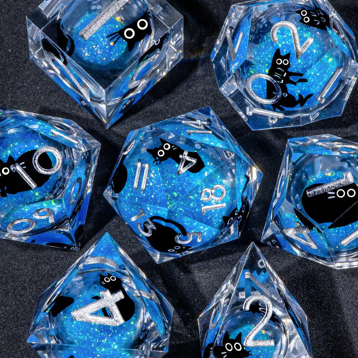 A collection of clear blue liquid core resin dice in various geometric shapes and angles
