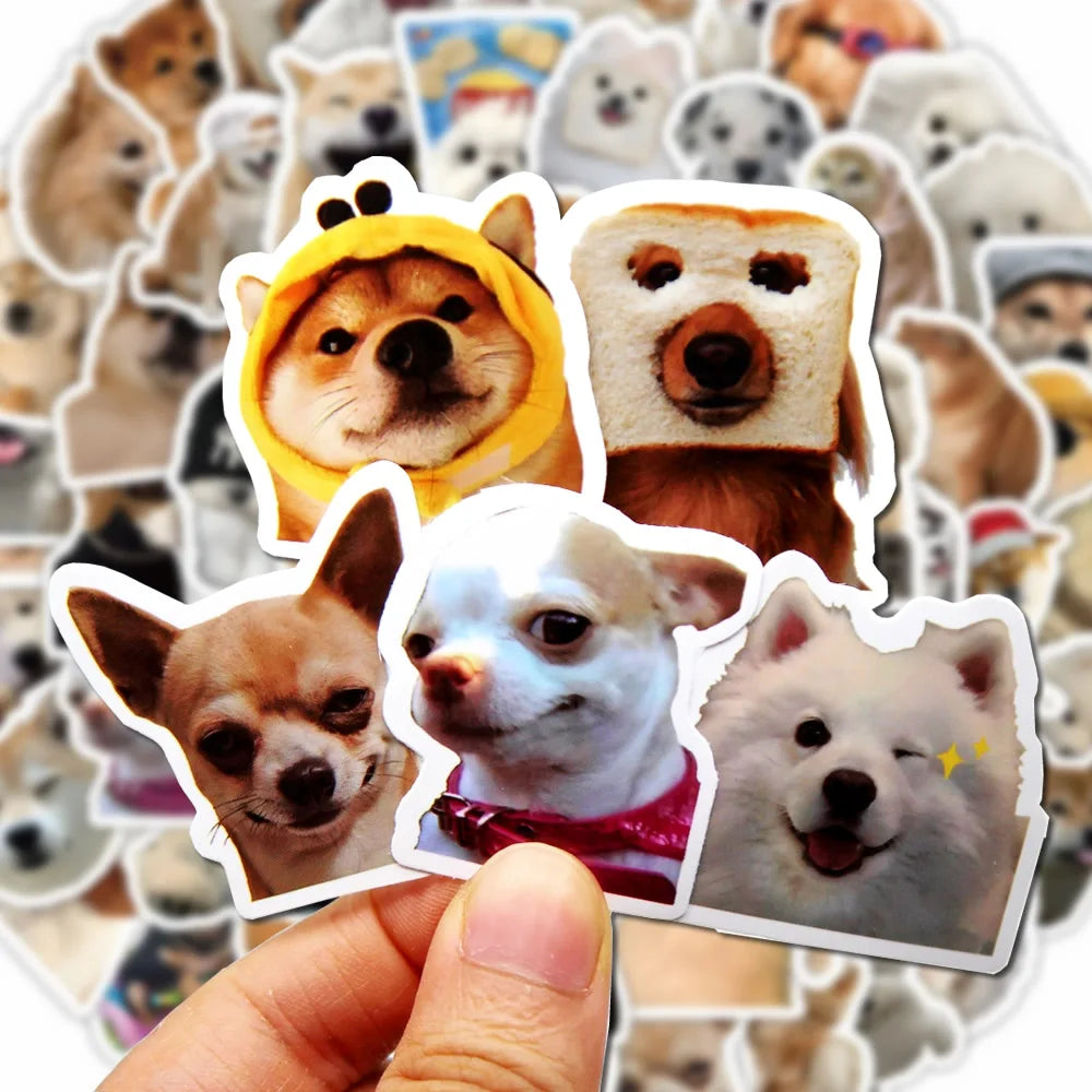 A hand holds a collection of funny dog stickers featuring various breeds and expressions.